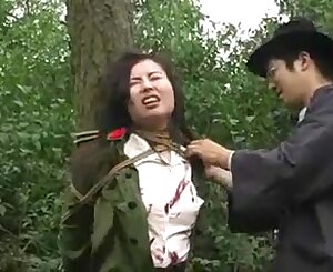 Asian army doll roped to tree 1